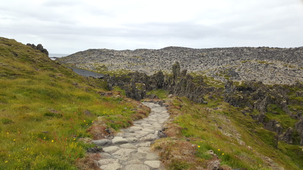 A path leading around a bend with strange rock formations
