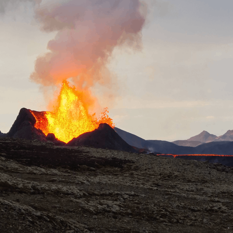 A volcano erupting with hot magma spewing into the air